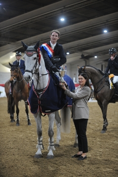 Paul Sims raised the Lesley McNaught Memorial Trophy as winner of the Audevard Winter 1.35m Championship at the British Showjumping Spring Championships